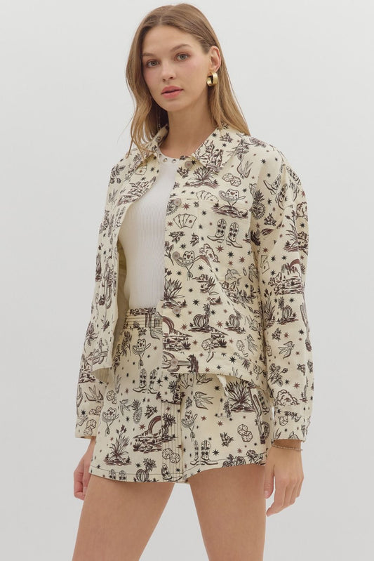 Woman wearing a patterned shirt over a white top on a plain background