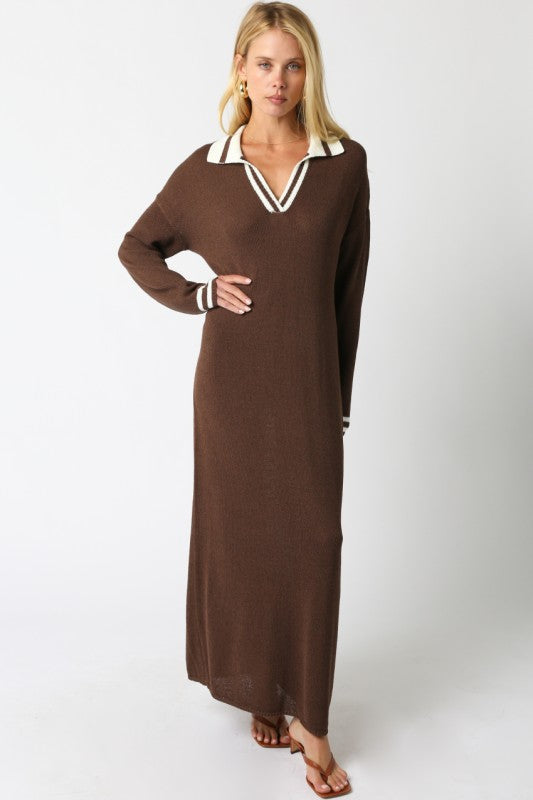 Woman wearing a brown dress with white trim on a white background