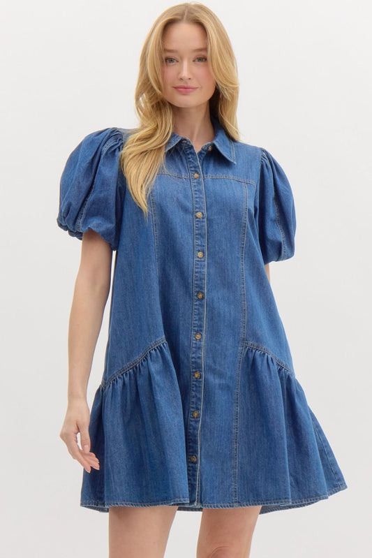 Woman wearing a blue denim dress with puff sleeves on a white background