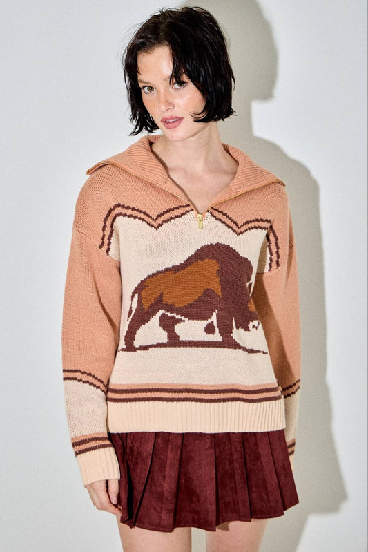 Woman wearing a sweater with a bear design on a plain background