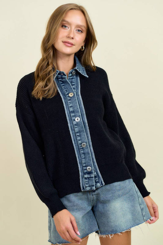 Woman wearing a black sweater with denim collar and shorts on a beige background
