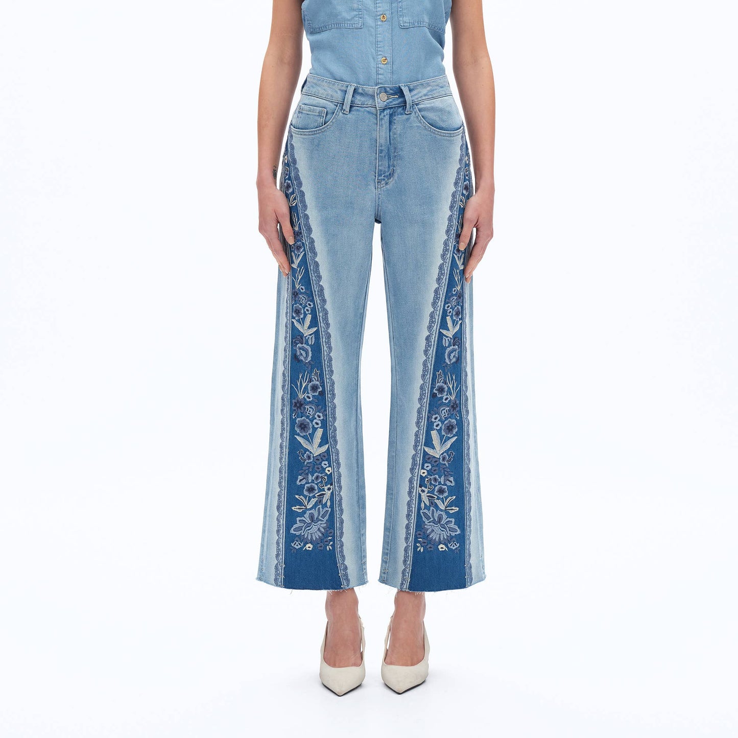 Blue jeans with floral embroidery on a white background