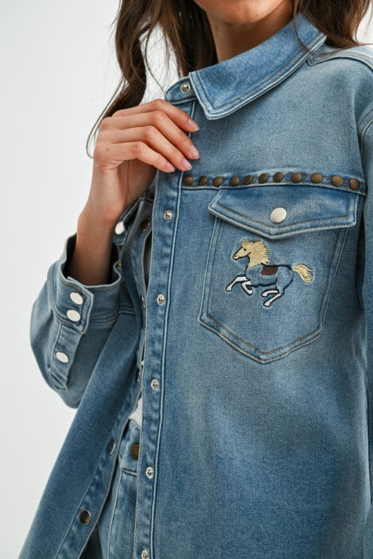 Blue denim jacket with a horse emblem on a white background