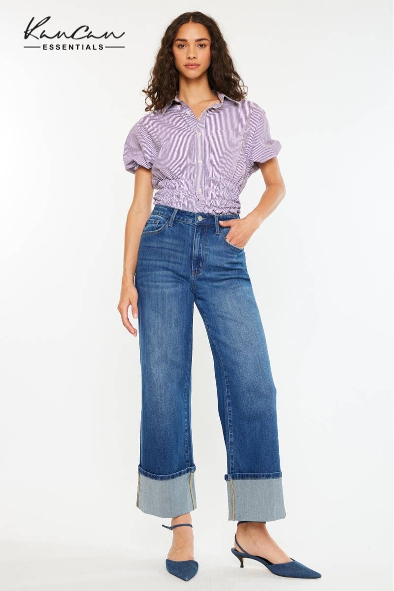 Woman wearing a purple blouse and blue jeans on a white background with Karen Scott logo.