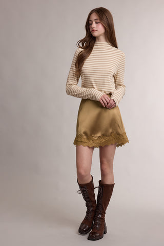 Tan satin mini skirt with lace hem trim, styled with striped top and brown boots