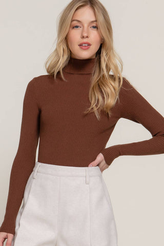 Brown ribbed knit turtleneck long sleeve fitted sweater on female model