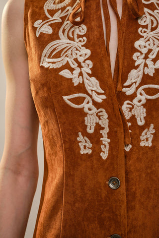 Tan suede sleeveless vest with cream floral embroidery and tie neck detail