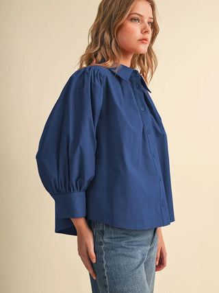 Cobalt blue button-front blouse with puff sleeves and point collar