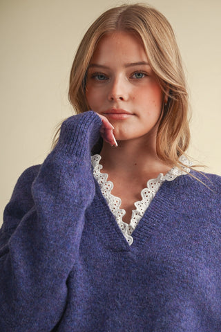 Purple V-neck sweater with white eyelet lace ruffle trim at neckline and cuffs