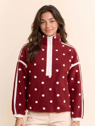 Wine red polka dot fleece half-zip pullover with white stripes and ribbed cuffs
