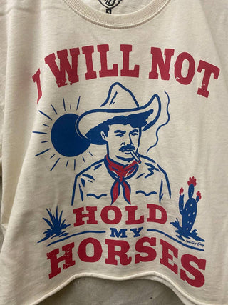 White cropped tee with red and blue cowboy graphic reading I Will Not Hold My Horses