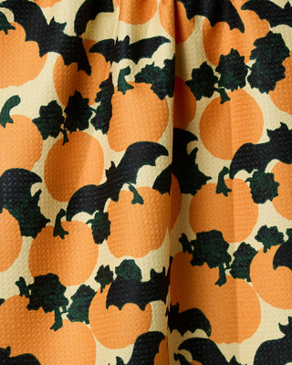 Halloween tea towel with orange pumpkins and black bats on cream background