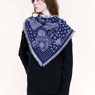 Navy blue paisley bandana triangle scarf with fringe edges worn over black sweater