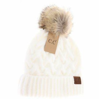 White chunky cable knit C.C beanie with tan faux fur pom pom on top