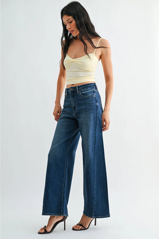 Dark wash high-rise wide-leg jeans with front seam detail and frayed hem