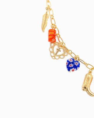 Gold chain necklace with feather, cross, heart, boot charms and orange blue glass beads