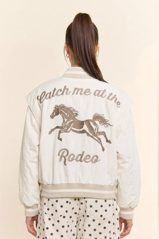 Cream bomber jacket with embroidered horse and 'Catch me at the Rodeo' text on back
