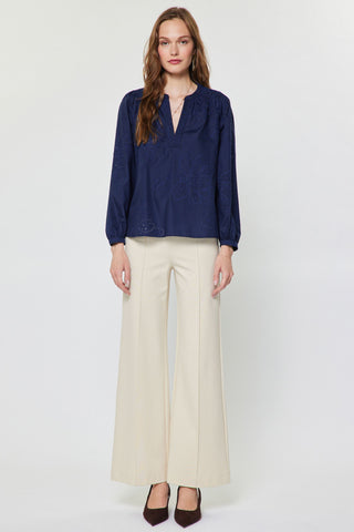 Navy blue long-sleeve eyelet embroidered blouse with floral pattern and split neckline