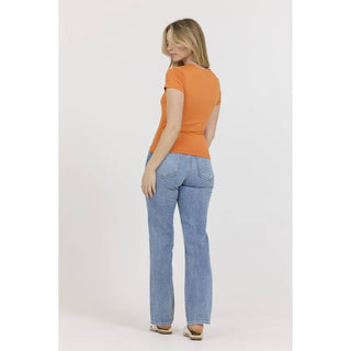 Women's orange crew neck short sleeve fitted knit tee, back view with jeans