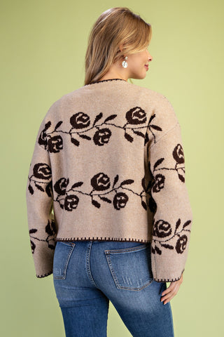 Gigio beige knit cardigan with dark brown rose floral pattern, worn with blue jeans
