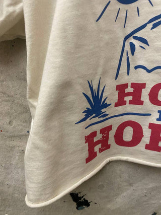 White cropped t-shirt with red and blue Western desert graphic print detail