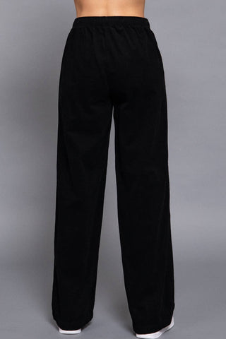 Black wide-leg corduroy pants with elastic waistband, back view