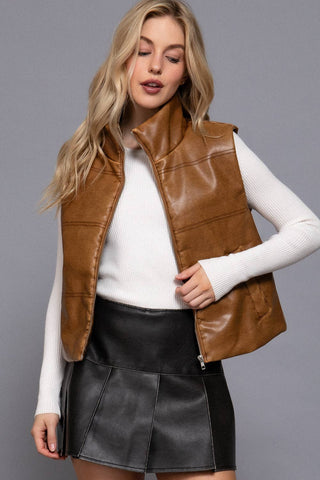 Tan faux leather puffer vest with zip front over white ribbed long sleeve top