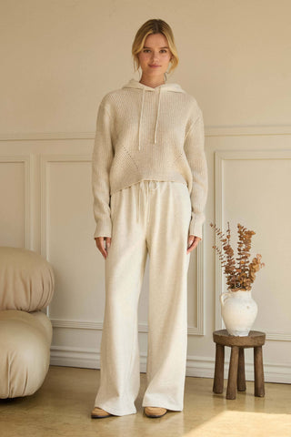Wide-leg cream soft knit drawstring pants with relaxed fit and clean seams