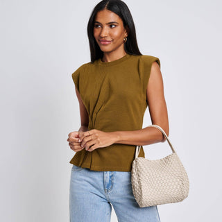 Cream woven leather crossbody bag with double handles, worn on shoulder