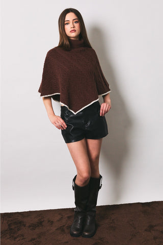 Brown cable knit turtleneck poncho with cream crochet trim edges