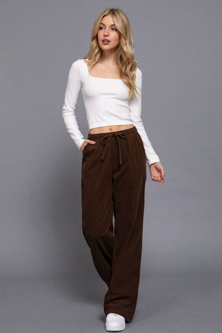 Chocolate brown wide-leg corduroy pants with elastic drawstring waist and side pockets