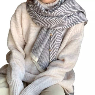 Cream knit poncho styled with gray chevron scarf, cozy winter look