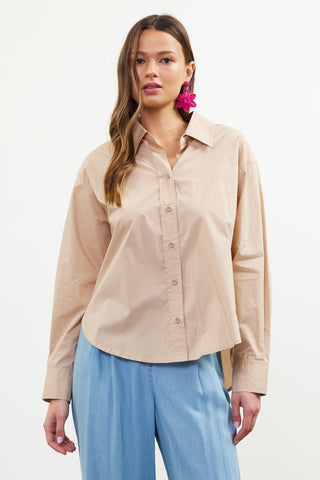 Women's tan long sleeve button-down cotton shirt with collared neckline and relaxed fit