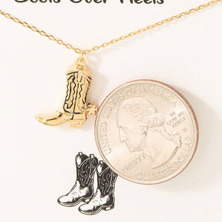 Gold dipped cowboy boot charm pendant on delicate gold chain necklace shown beside quarter for scale