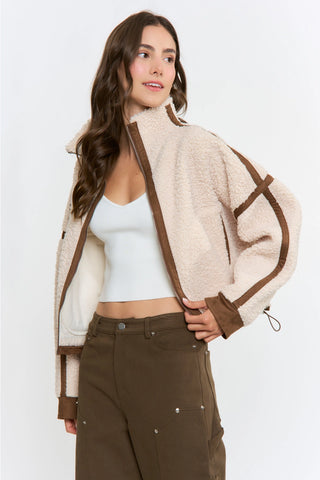 Cream sherpa zip-up jacket with brown suede trim detailing and mock neck