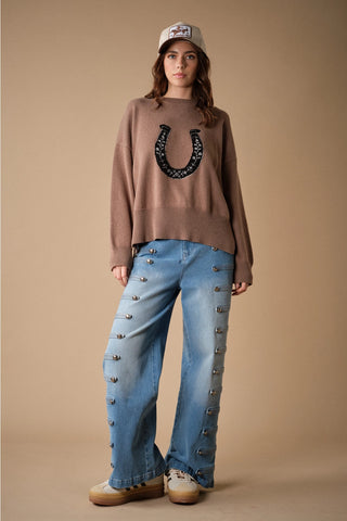 Oversized mocha knit sweater with black embroidered horseshoe graphic on chest