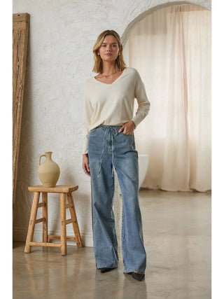 Wide-leg light wash blue denim pants with drawstring waist and side stripe detail