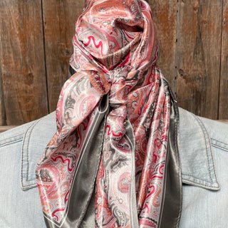 Pink and grey paisley satin wild rag scarf tied loosely over denim jacket