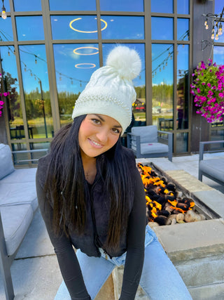 White cable knit beanie with pearl embellished cuff and faux fur pom-pom