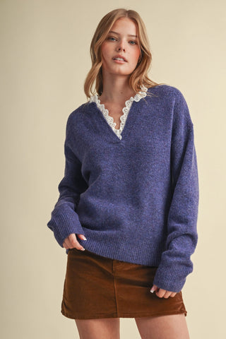 Navy blue V-neck sweater with white eyelet lace ruffle collar trim