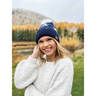 Navy blue C.C beanie with white star print and white pom pom top