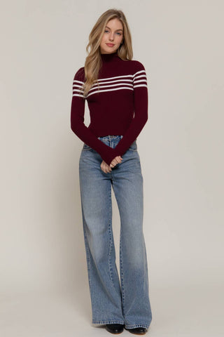Burgundy ribbed turtleneck sweater with white chest stripes, long sleeves
