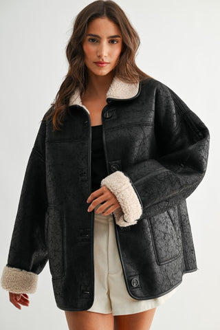 Black faux leather reversible sherpa jacket with cream fleece lining and cuffs
