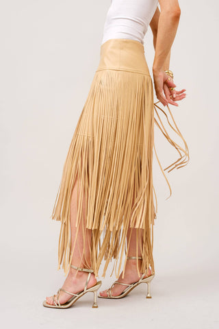 Taupe leather fringe maxi skirt with layered fringe detail, paired with gold heels