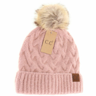 Pink cable knit C.C beanie with cream faux fur pom pom and cuffed brim