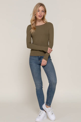 Olive green ribbed long sleeve round neck fitted tee paired with blue skinny jeans