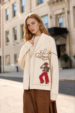 Ivory knit cardigan with cowboy jacquard motif, shawl collar, open front relaxed fit