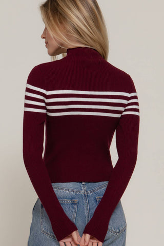Burgundy ribbed turtleneck sweater with white chest stripes and long sleeves