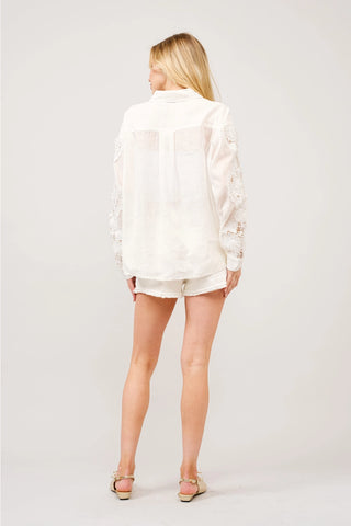 Off white long sleeve button-up blouse with crochet lace sleeves, back view