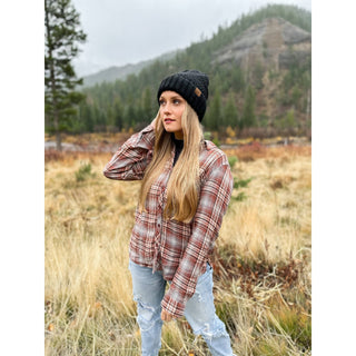 Black cable knit C.C beanie with fuzzy lining worn by woman outdoors
